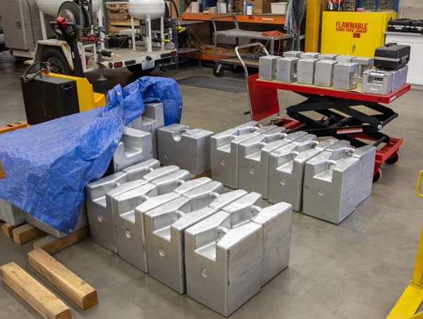 large weights on pallets and a cart