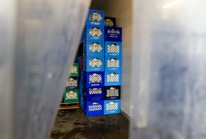 Crates of milk stacked in cold room.